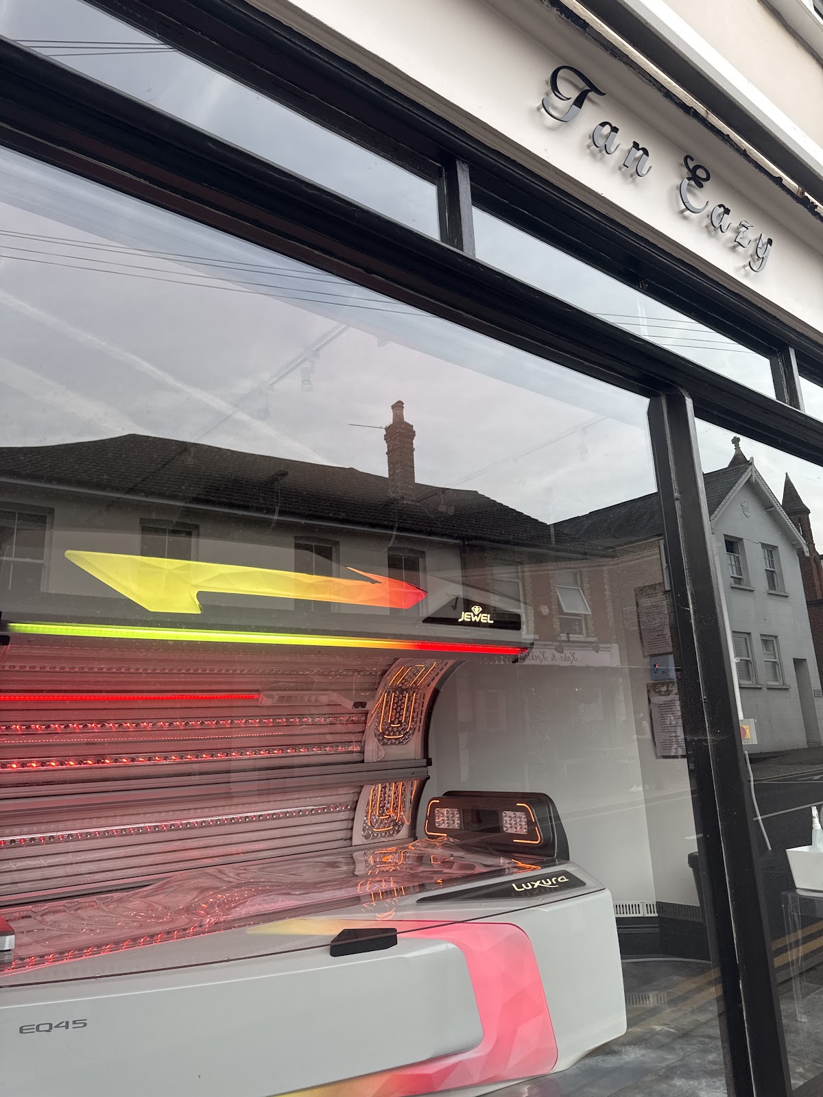 The Luxura Jewel EQ45 hybrid standup at Tan Eazy, red light strips visible alongside the UV tubes